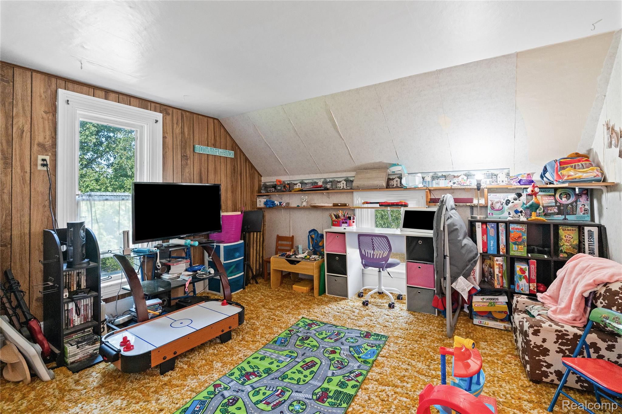 1175 South Morrish Road Flint, MI 48532 - Photo 45 of 72 Attic room featuring wood-paneled walls and a window with exterior tree views