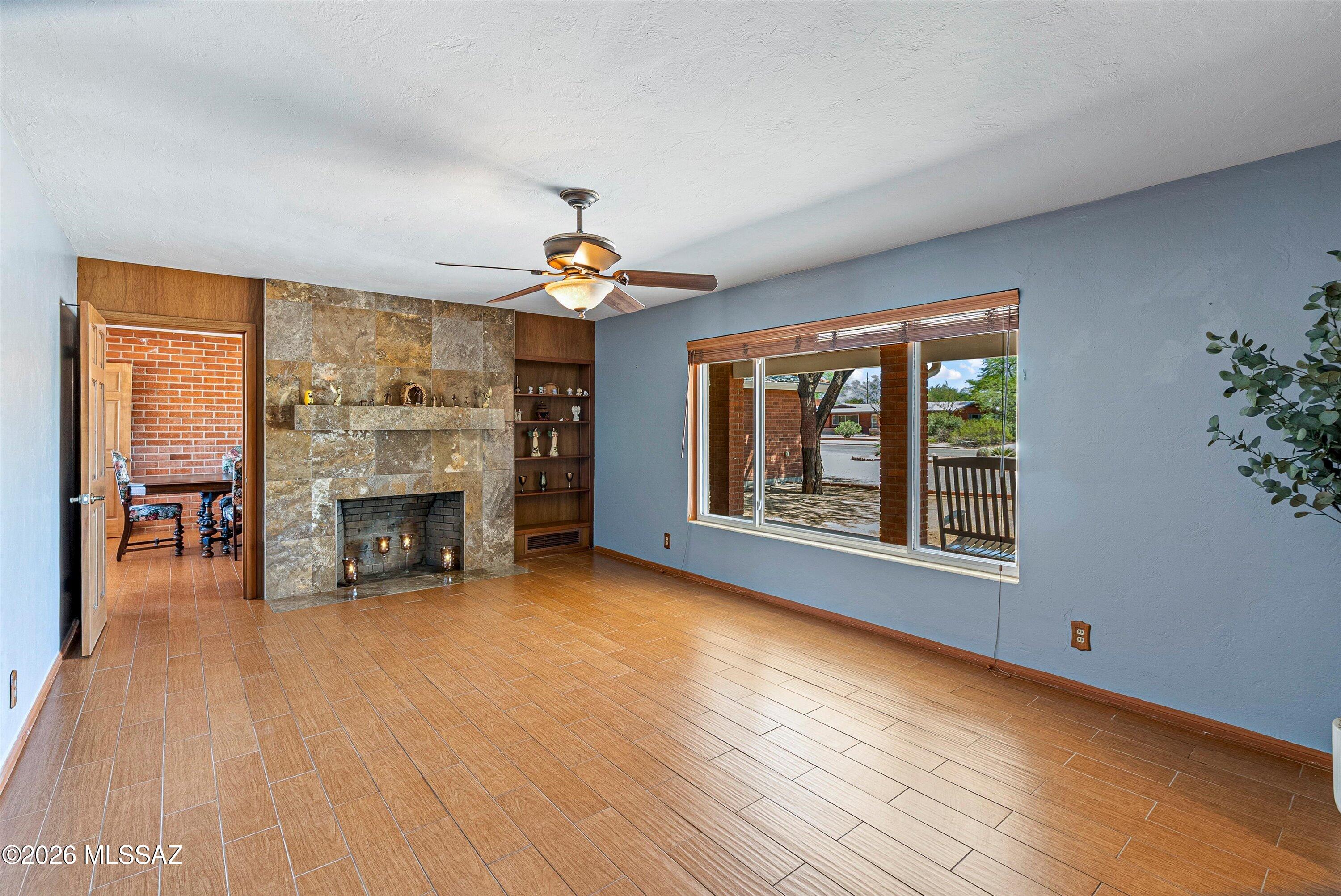 2107 East Lind Road Tucson, AZ 85719 - Photo 9 of 43 a view of an empty room with a window and fireplace