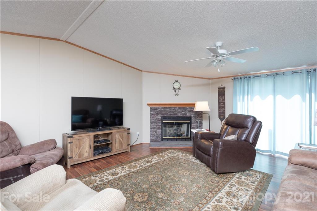 1465 Humphries Road Clover, SC 29710 - Photo 14 of 47 a living room with furniture a flat screen tv and a fireplace