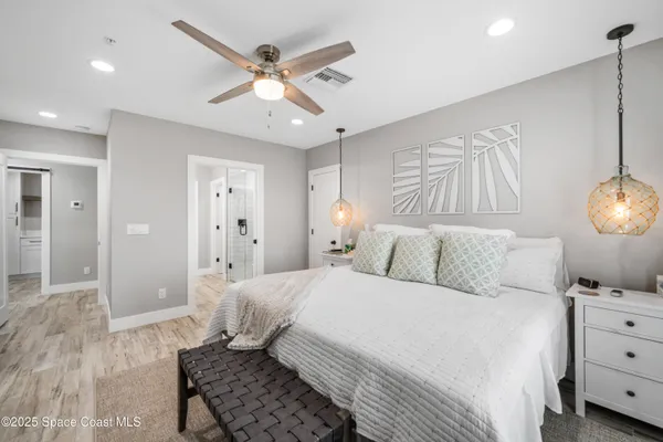 a bedroom with a bed and a chandelier