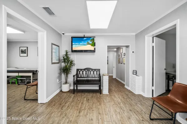 a view of a room with wooden floor and furniture