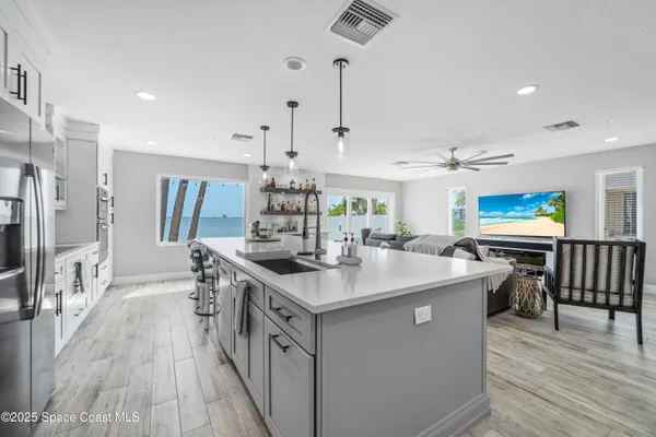 a kitchen with stainless steel appliances kitchen island a large island in the center