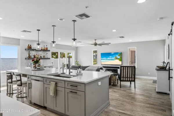 a kitchen with stainless steel appliances kitchen island granite countertop a sink and cabinets