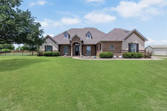 a front view of a house with a yard