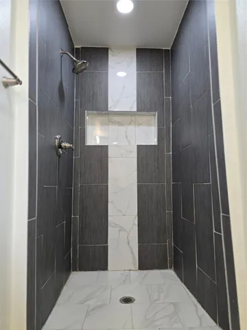 a bathroom with a shower and a sink