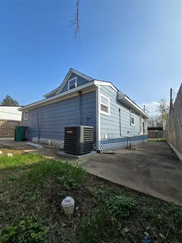 a backyard of a house with table and chairs
