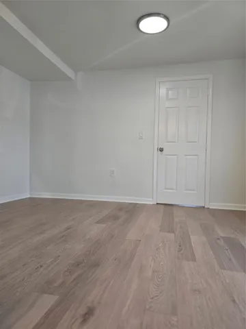 a view of an empty room and wooden floor