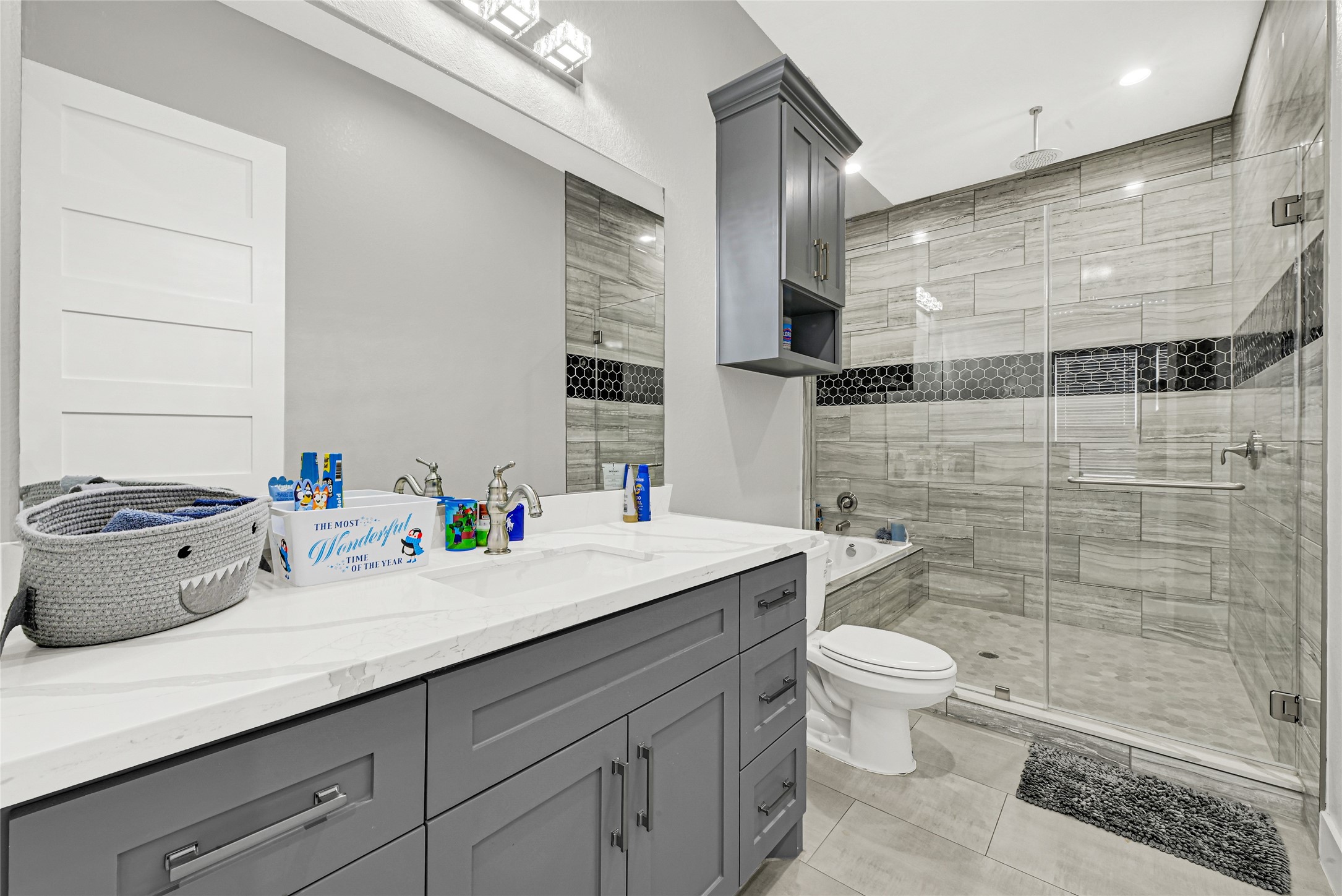 4821 1st Street Houston, TX 77504 - Photo 27 of 48 a bathroom with a toilet a sink and mirror