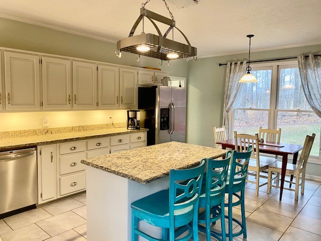 796 Dripping Springs Road Winchester, TN 37398 - Photo 11 of 34 a kitchen with granite countertop a table chairs sink and cabinets