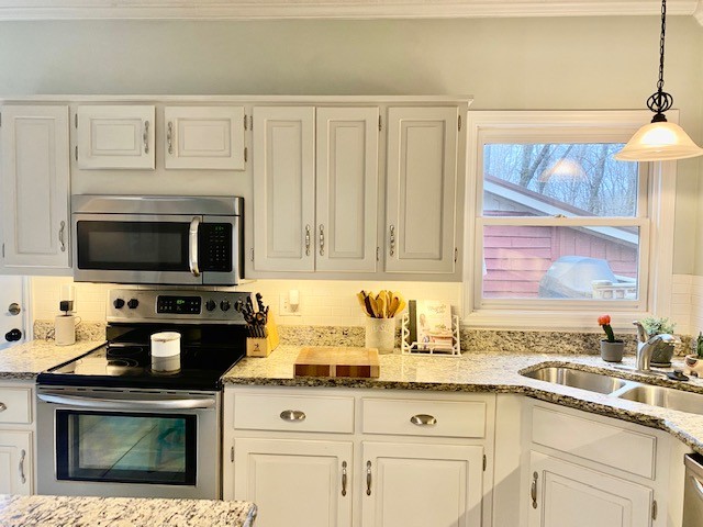 796 Dripping Springs Road Winchester, TN 37398 - Photo 10 of 34 a kitchen with granite countertop a stove a sink and a microwave