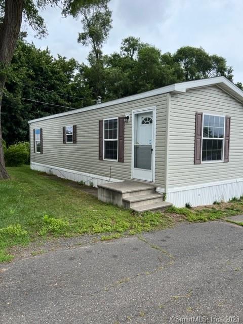 9 N Road, Unit 8 East Windsor, CT 06088 - Photo 1 of 1 a house with trees in the background