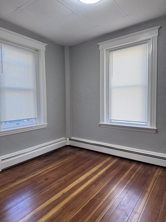 36 Endicott Street, Unit 1R Salem, MA 01970 - Photo 8 of 9 a view of a room with wooden floor and fan