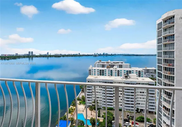 a kitchen with a refrigerator a stove a sink dishwasher and wooden cabinets