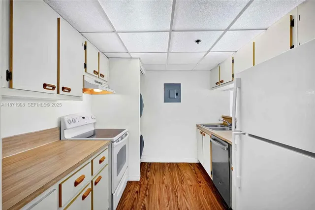 a bathroom with a granite countertop sink a toilet a mirror and shower