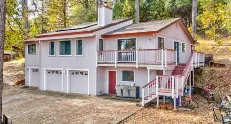a view of a house with a yard and lawn chairs