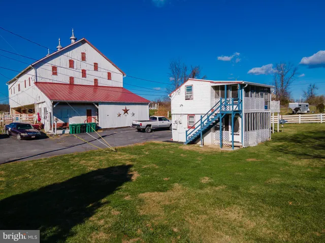 a front view of a house with a yard table and chairs