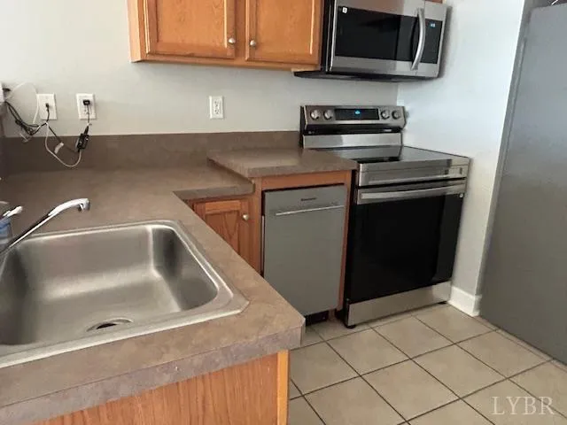 a kitchen with stainless steel appliances granite countertop a sink and a stove