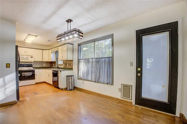 a living room with furniture a fireplace and wooden floor