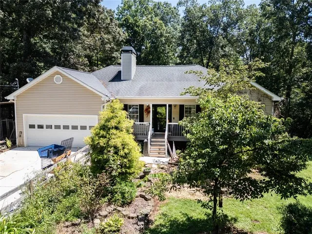 an aerial view of a house with a yard basket ball court and outdoor seating