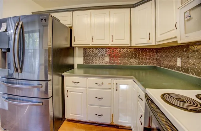 a kitchen with a sink stove and cabinets