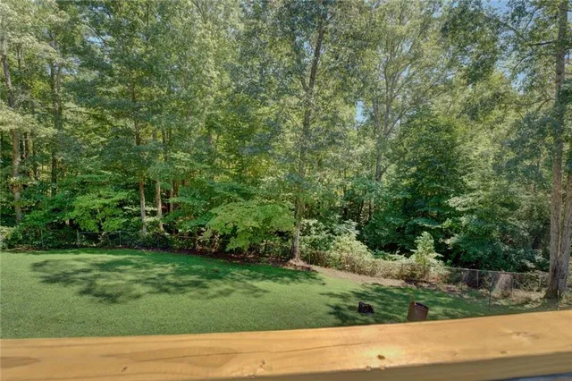 a view of balcony with wooden floor and fence
