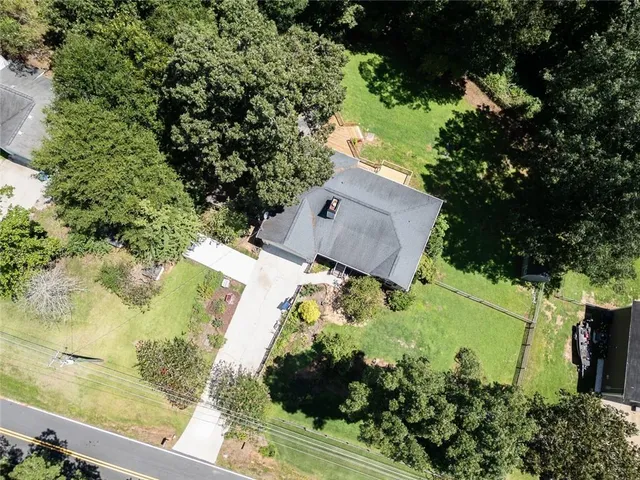 an aerial view of a house with a yard