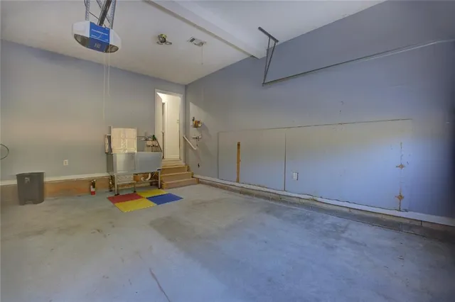 a view of a house with a big yard and large tree