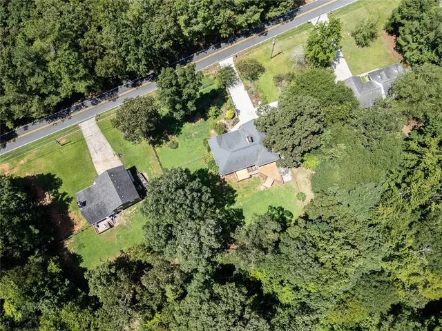 an aerial view of a house with a yard