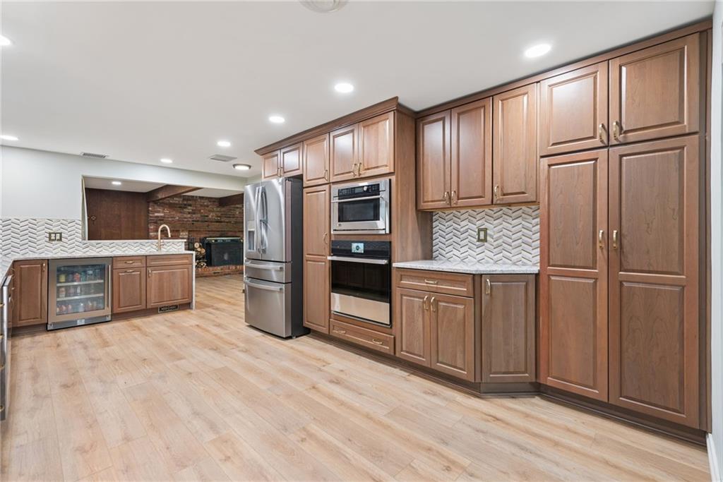 22 Buzzardtown Road Irwin, PA 15642 - Photo 8 of 44 a kitchen with stainless steel appliances granite countertop a refrigerator and wooden cabinets