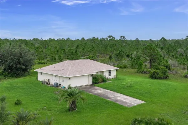 a view of a big house with a big yard