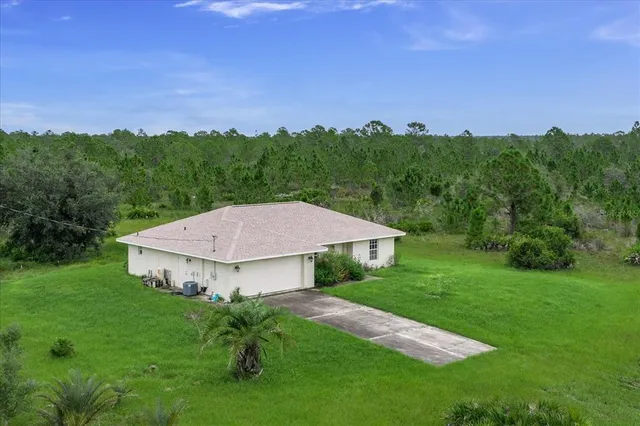 a view of a big house with a big yard