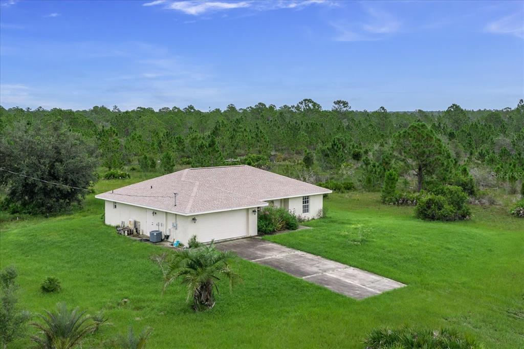 a view of a big house with a big yard