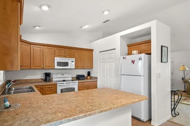 a kitchen with refrigerator cabinets and a counter top space