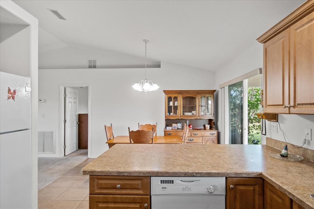 30 Milky Way Venus, FL 33960 - Photo 15 of 45 a kitchen with kitchen island a counter top space a sink a refrigerator and a large window