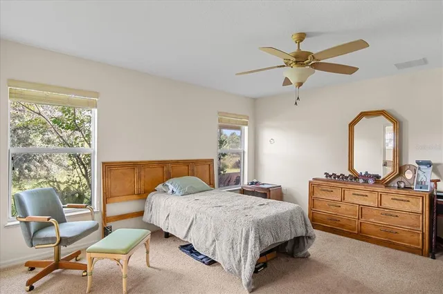 a bedroom with a bed and ceiling fan
