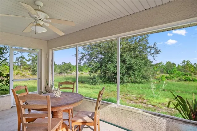 a view of a porch with furniture and backyard