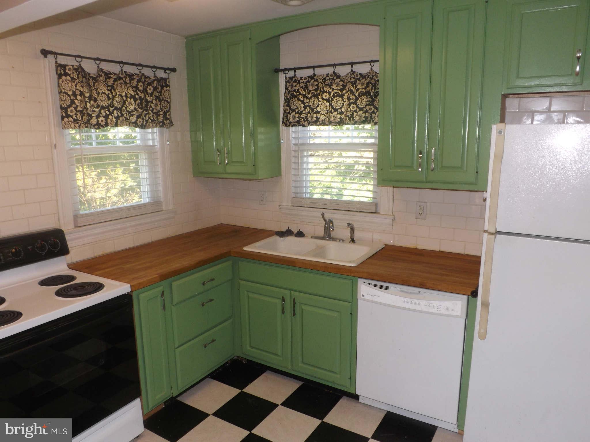 60 Cox Road Huntingtown, MD 20639 - Photo 2 of 15 a kitchen with stainless steel appliances granite countertop a sink and a refrigerator