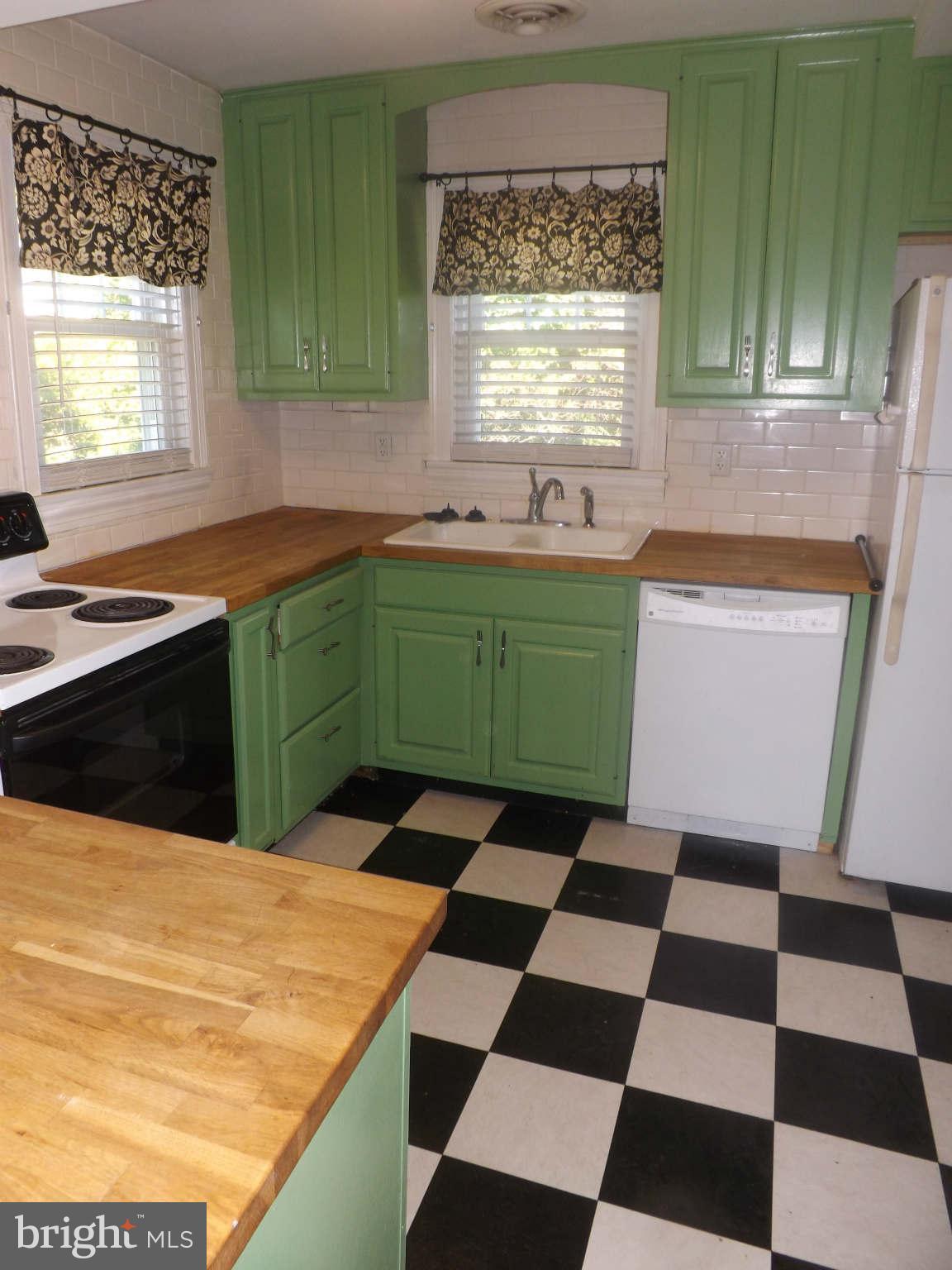60 Cox Road Huntingtown, MD 20639 - Photo 3 of 15 a kitchen with a sink a stove and a window