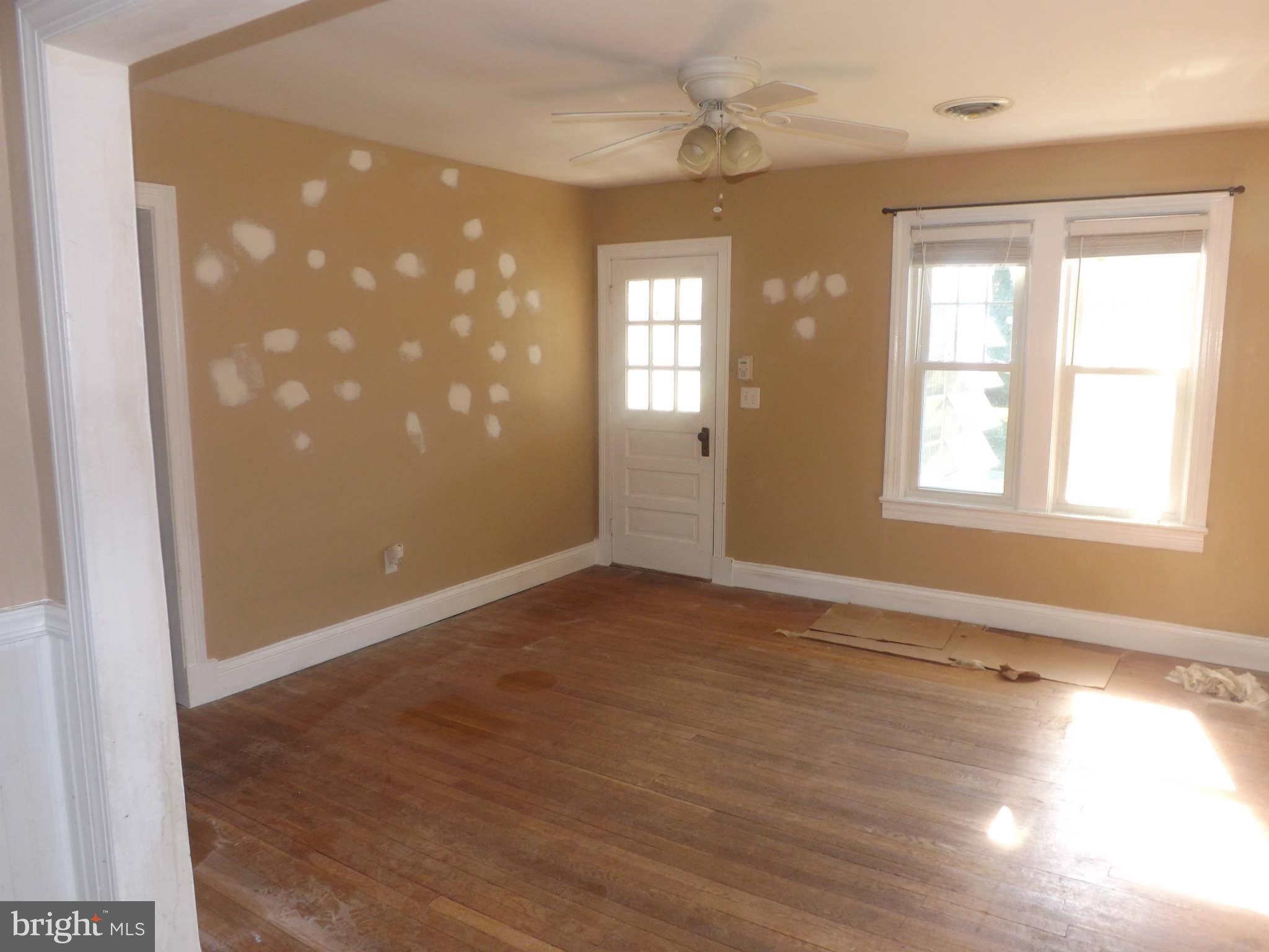 60 Cox Road Huntingtown, MD 20639 - Photo 4 of 15 an empty room with wooden floor and windows