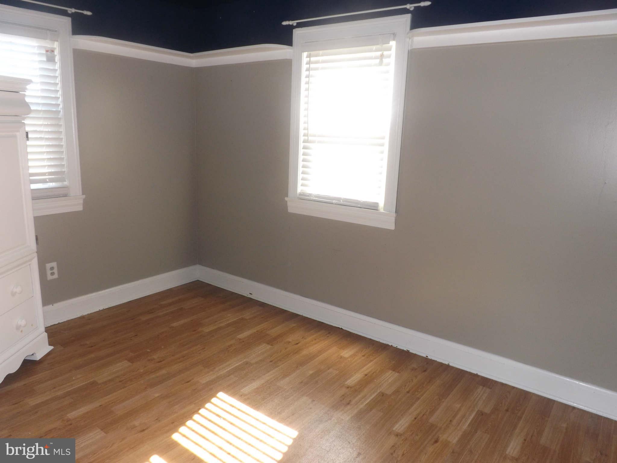 60 Cox Road Huntingtown, MD 20639 - Photo 5 of 15 a view of an empty room with wooden floor and a window