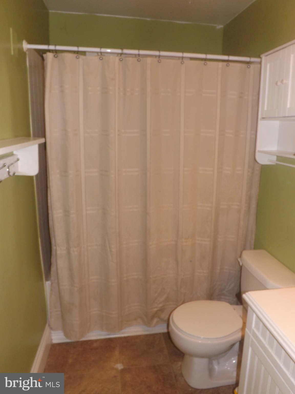 60 Cox Road Huntingtown, MD 20639 - Photo 6 of 15 a white toilet sitting next to a shower curtain