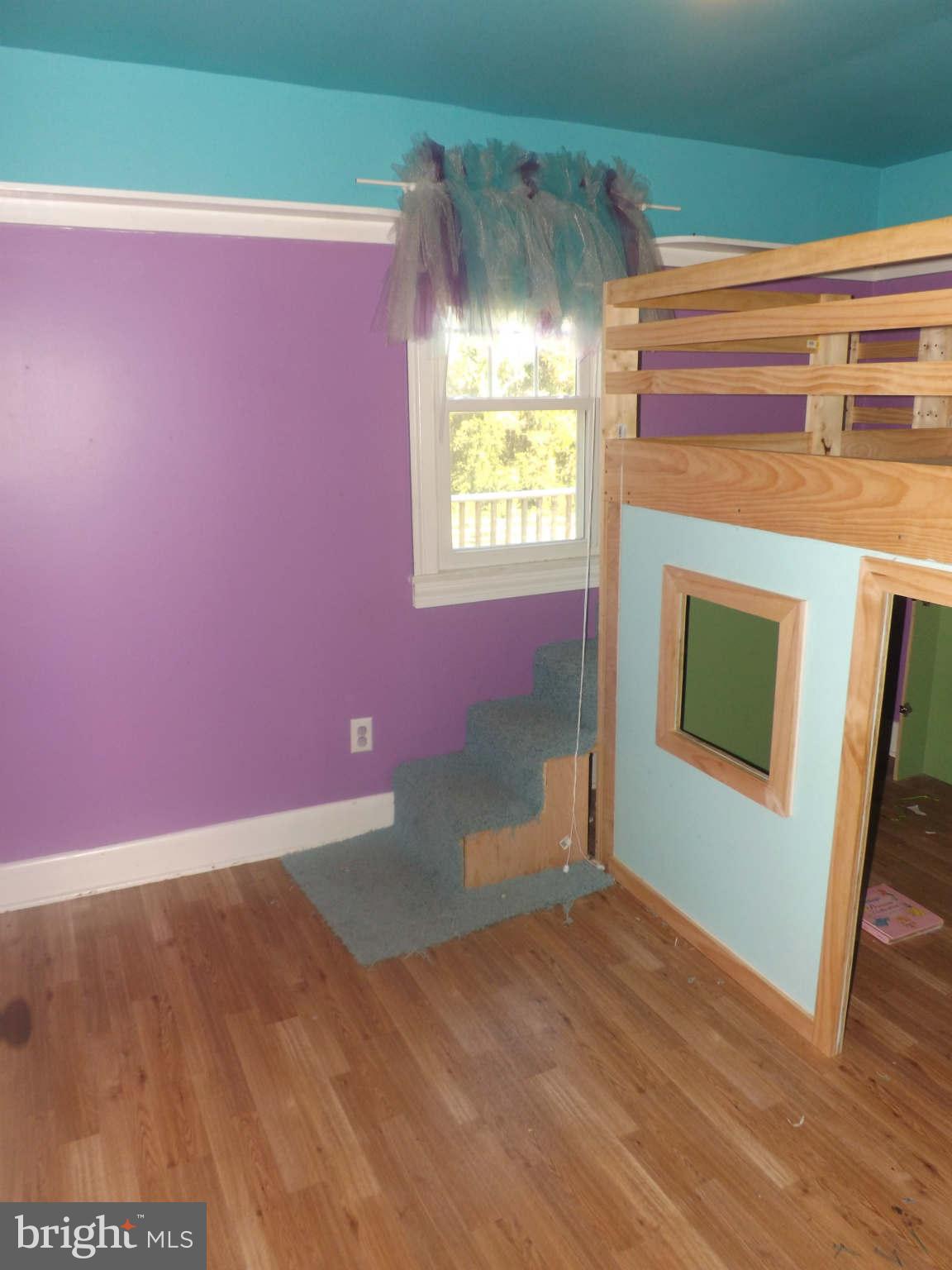 60 Cox Road Huntingtown, MD 20639 - Photo 7 of 15 a view of an empty room with wooden floor and a window