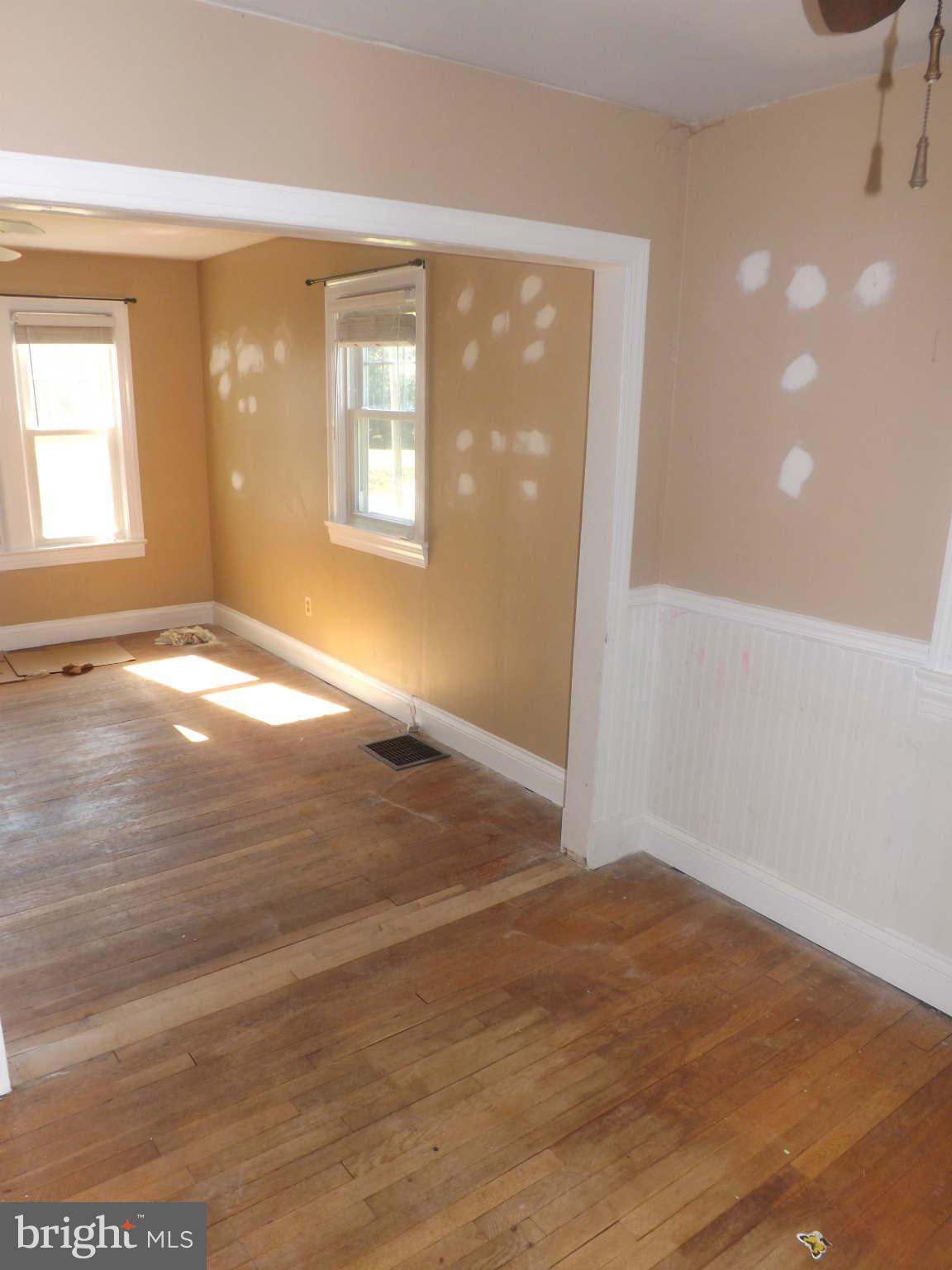60 Cox Road Huntingtown, MD 20639 - Photo 8 of 15 a view of empty room with wooden floor and fan