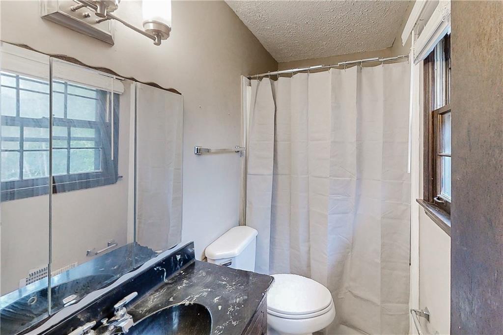 2284 Emerald Springs Drive Decatur, GA 30035 - Photo 19 of 30 a bathroom with a granite countertop sink toilet and shower