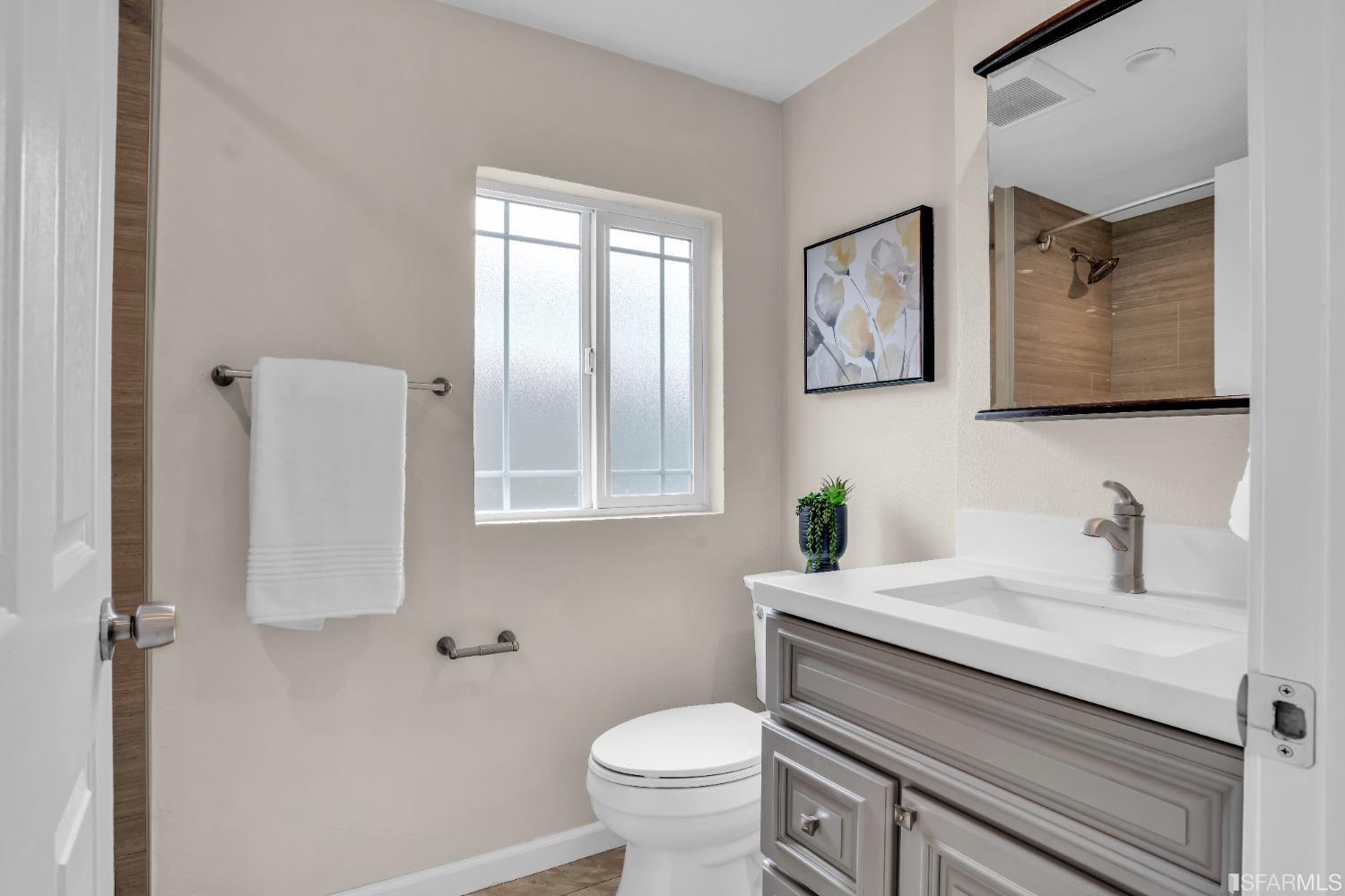 476 Violet Street San Leandro, CA 94578 - Photo 15 of 30 a bathroom with a toilet sink and mirror