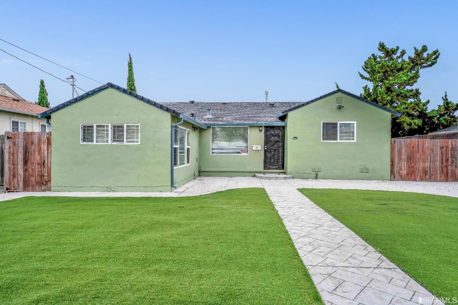 476 Violet Street San Leandro, CA 94578 - Photo 22 of 30 a front view of a house with a yard and garage