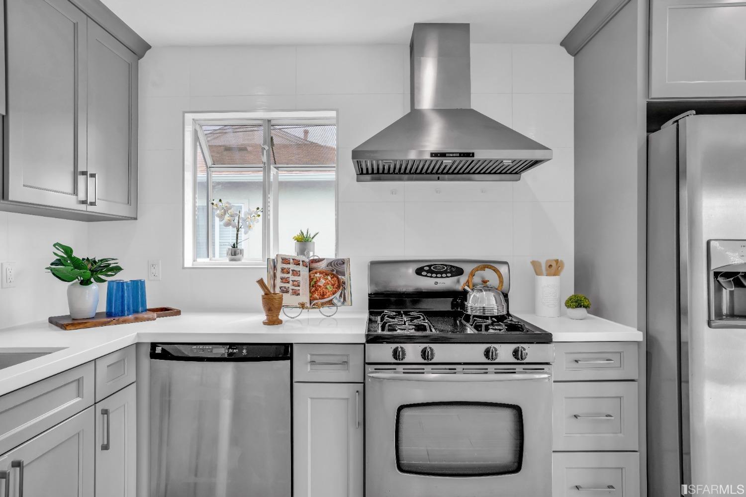 476 Violet Street San Leandro, CA 94578 - Photo 9 of 30 a kitchen with stainless steel appliances granite countertop a stove a refrigerator and a white cabinets