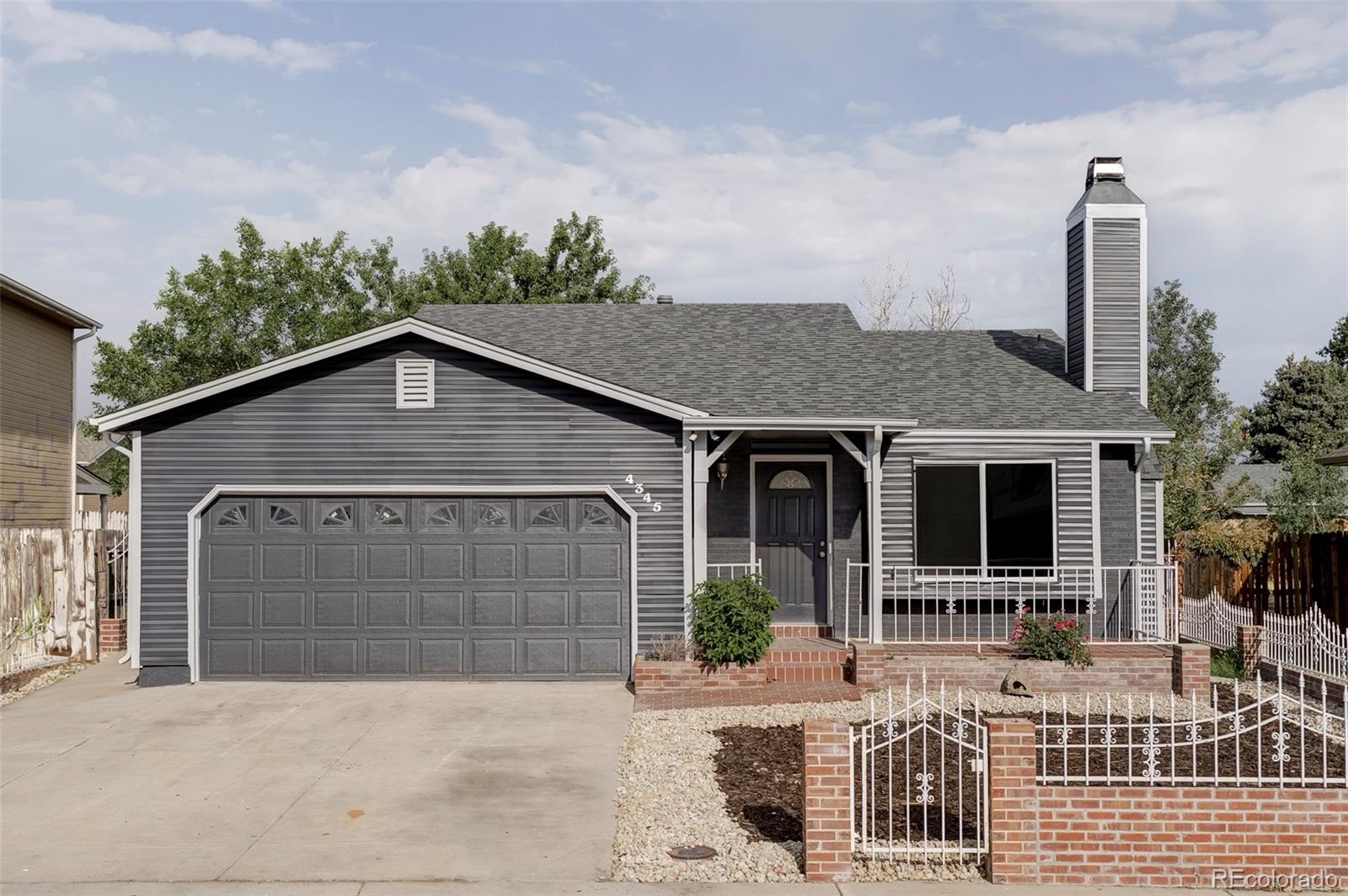 4345 Eagle Street Denver, CO 80239 - Photo 1 of 20 a front view of a house with yard outdoor seating and barbeque oven