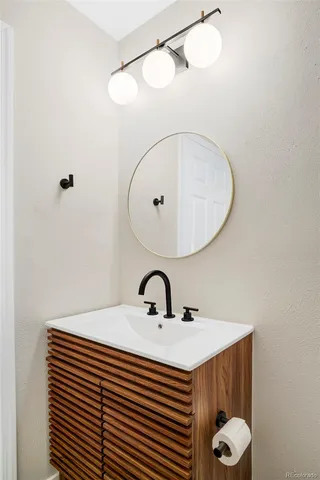 a bathroom with a sink a mirror and shower