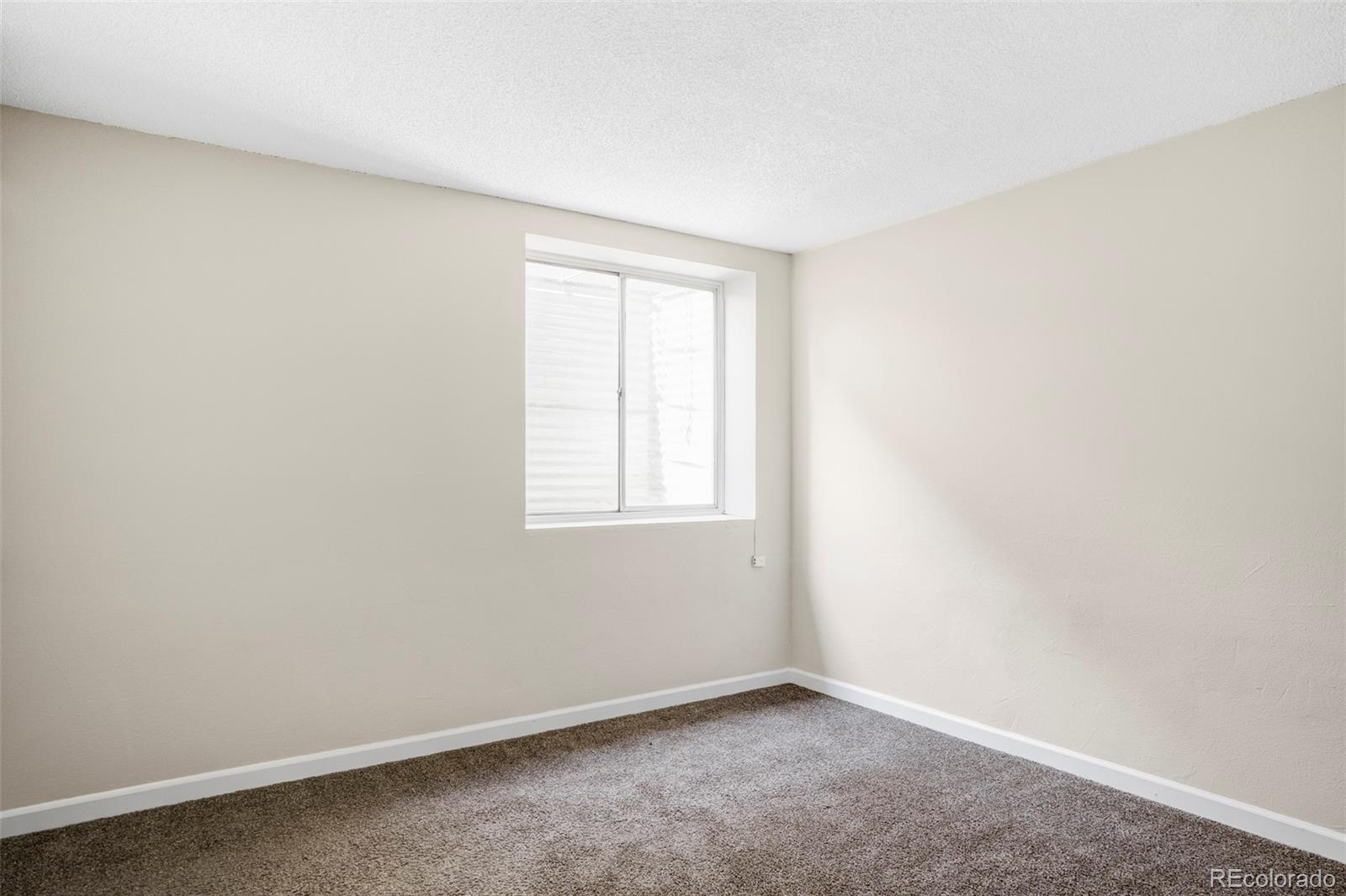 4345 Eagle Street Denver, CO 80239 - Photo 17 of 20 an empty room with a window